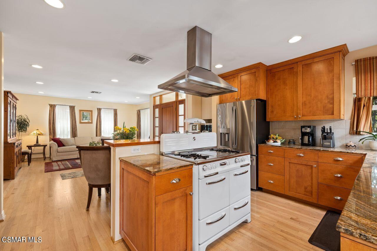 11616 Clarkson Road Los Angeles, CA 90064 - Photo 11 of 34 a kitchen with stainless steel appliances granite countertop a stove oven and a refrigerator