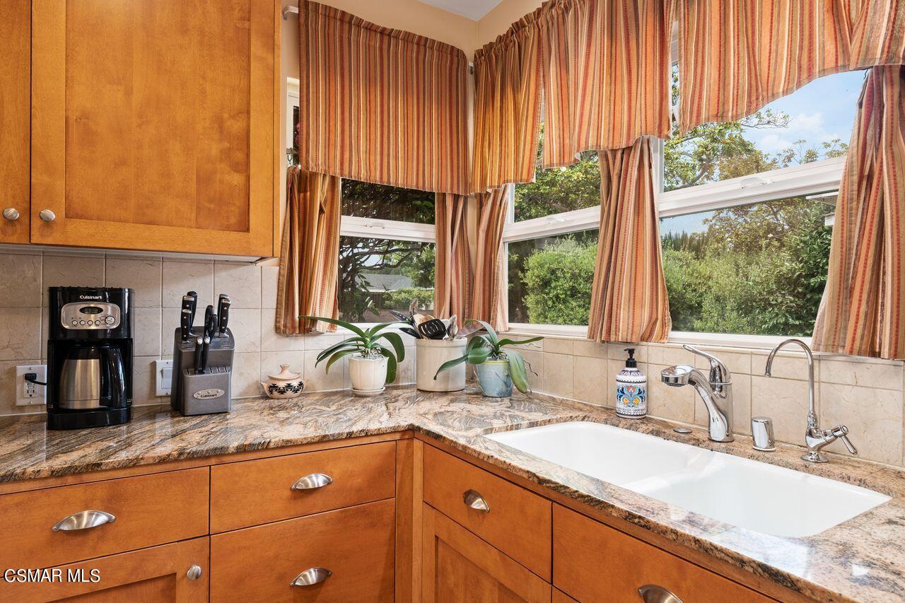 11616 Clarkson Road Los Angeles, CA 90064 - Photo 12 of 34 a kitchen with granite countertop a sink and a window