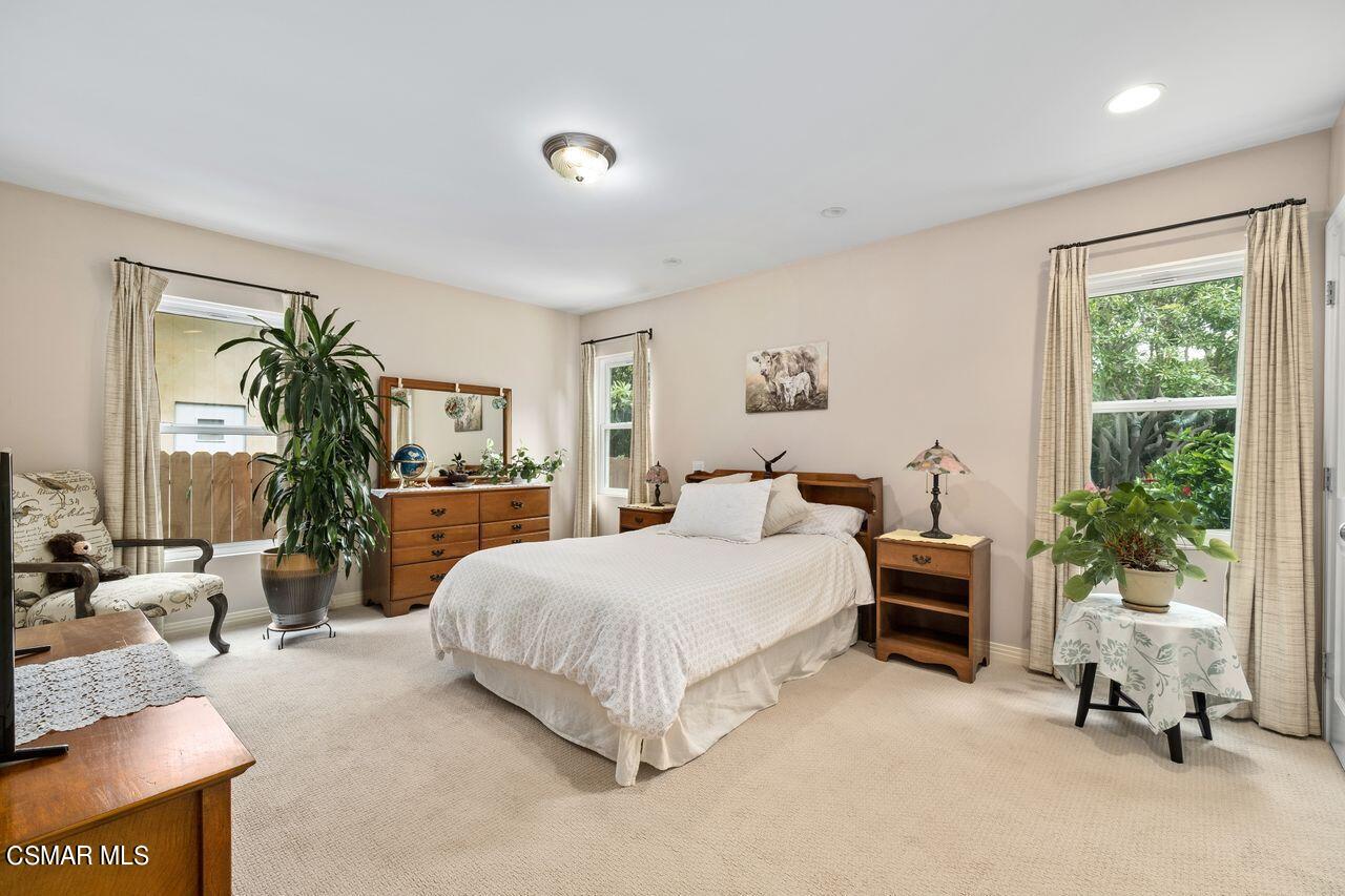 11616 Clarkson Road Los Angeles, CA 90064 - Photo 20 of 34 a bedroom with a large bed and potted plant with the outer view