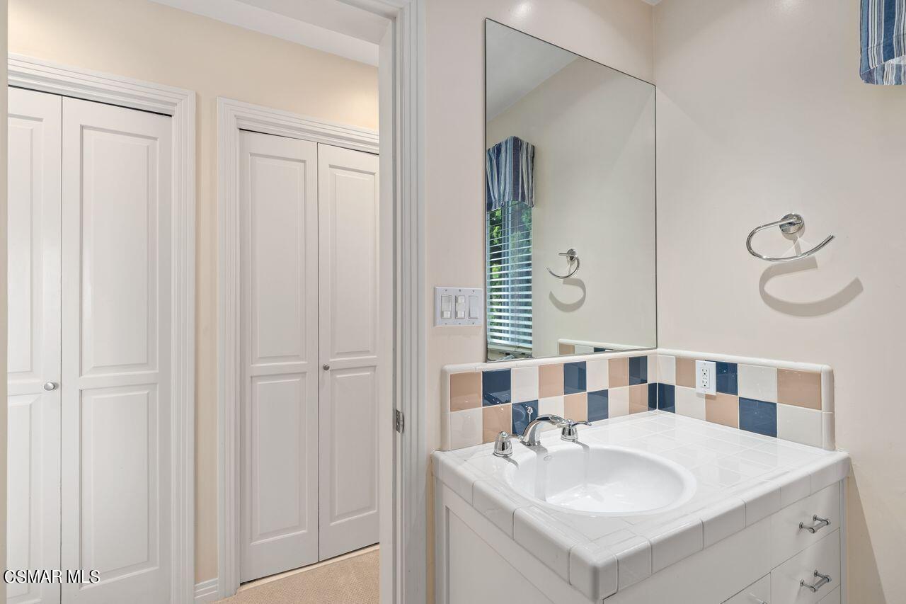 11616 Clarkson Road Los Angeles, CA 90064 - Photo 25 of 34 a bathroom with a sink and a mirror