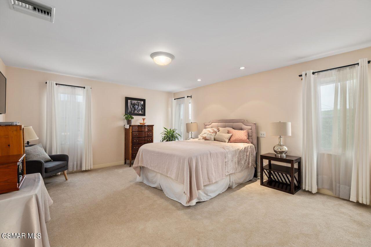 11616 Clarkson Road Los Angeles, CA 90064 - Photo 27 of 34 a spacious bedroom with a bed and a chair