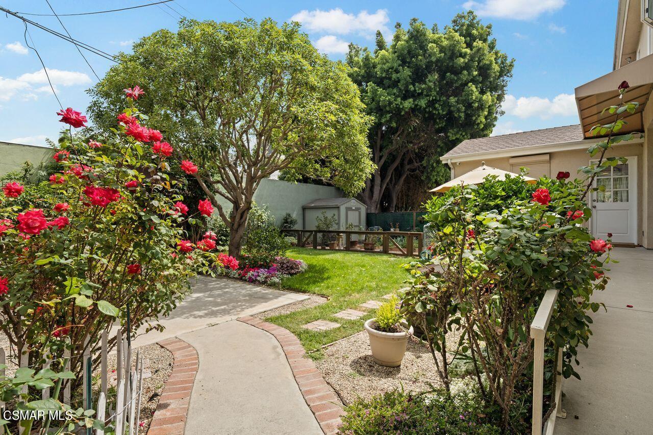 11616 Clarkson Road Los Angeles, CA 90064 - Photo 29 of 34 a front view of a house with a yard and fountain
