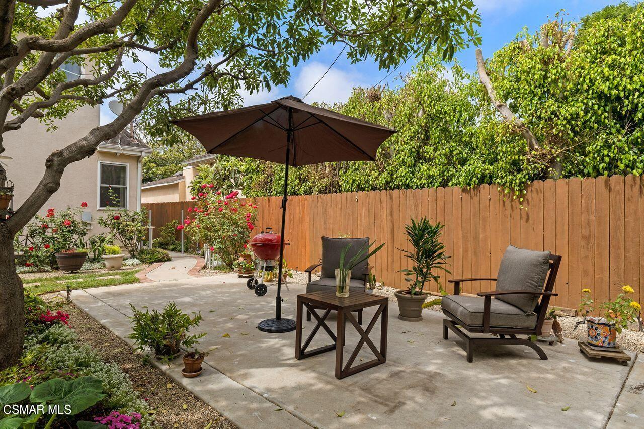 11616 Clarkson Road Los Angeles, CA 90064 - Photo 34 of 34 a backyard of a house with table and chairs under an umbrella