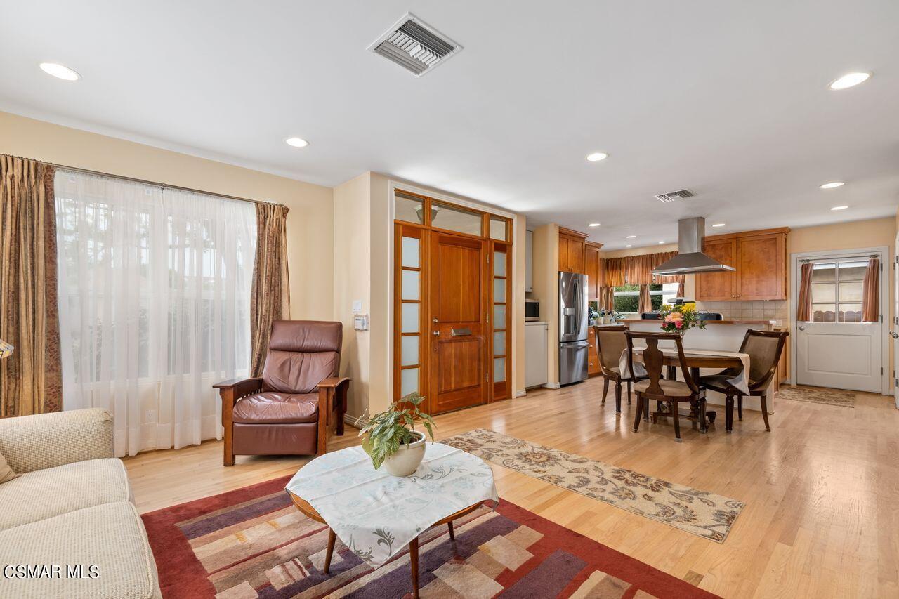 11616 Clarkson Road Los Angeles, CA 90064 - Photo 6 of 34 a living room with furniture and a dining table with rug kitchen