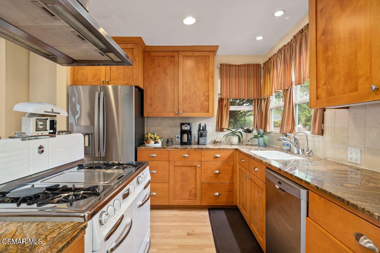 11616 Clarkson Road Los Angeles, CA 90064 - Photo 10 of 34 a kitchen with stainless steel appliances granite countertop a sink stove and refrigerator