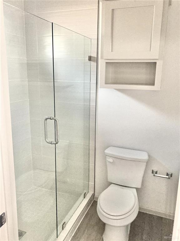 7702 North 58th Street, Unit 3 Mission, TX 78573 - Photo 8 of 11 Bathroom with a shower stall and wood finished floors