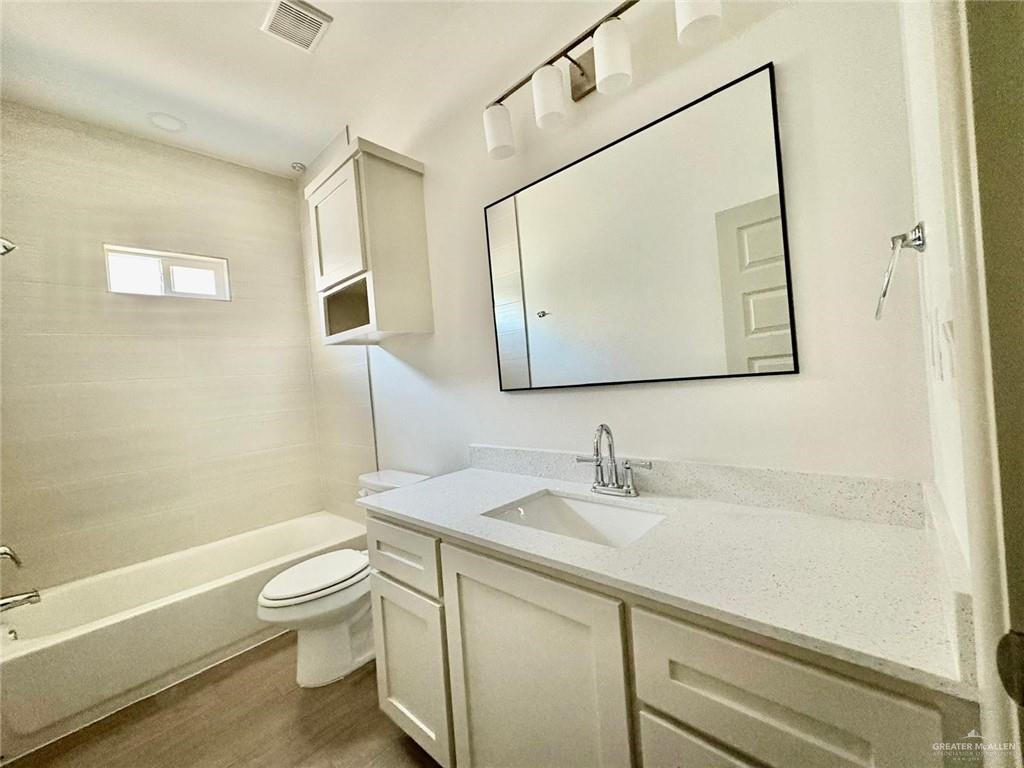 7702 North 58th Street, Unit 3 Mission, TX 78573 - Photo 10 of 11 Full bath featuring shower / bath combination, vanity, and dark wood-type flooring