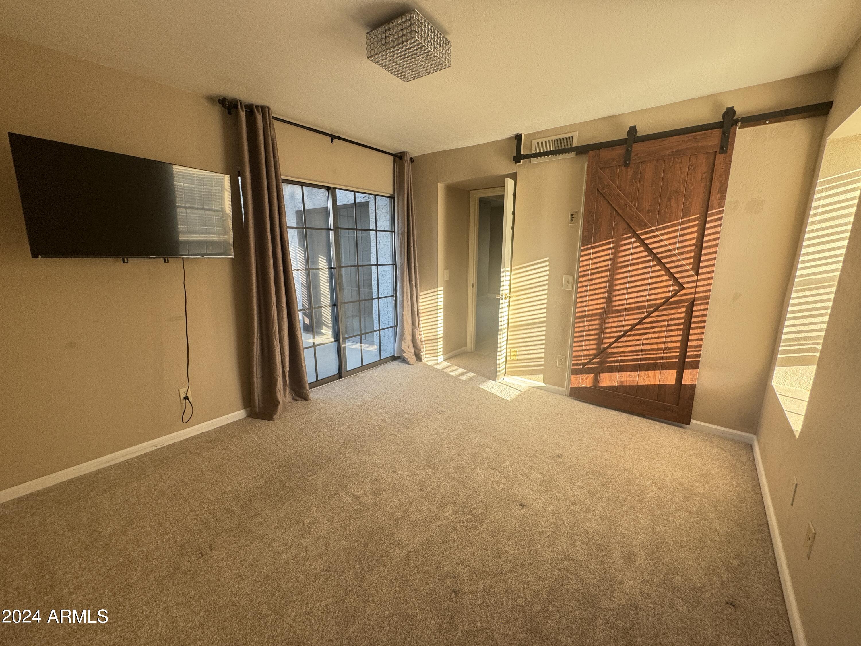 8020 East Thomas Road, Unit 226 Scottsdale, AZ 85251 - Photo 12 of 16 a view of a room with a flat screen tv