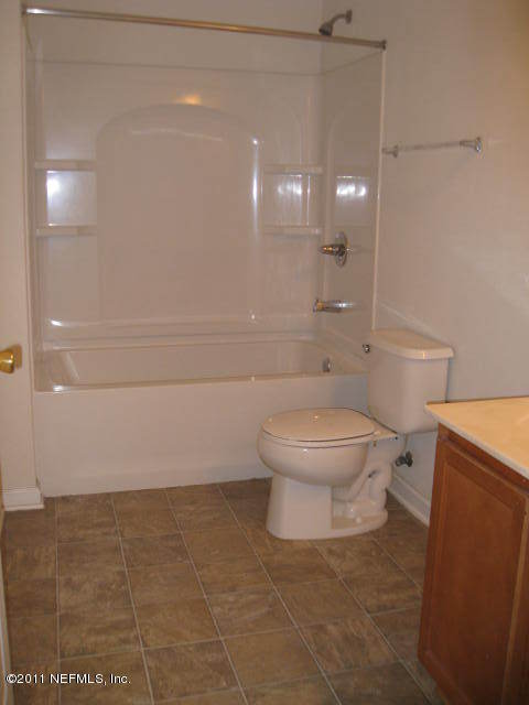 1108 Dawn Light Road Jacksonville, FL 32218 - Photo 14 of 19 a bathroom with a toilet a sink and shower