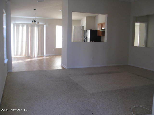 1108 Dawn Light Road Jacksonville, FL 32218 - Photo 4 of 19 en empty room with windows and fireplace
