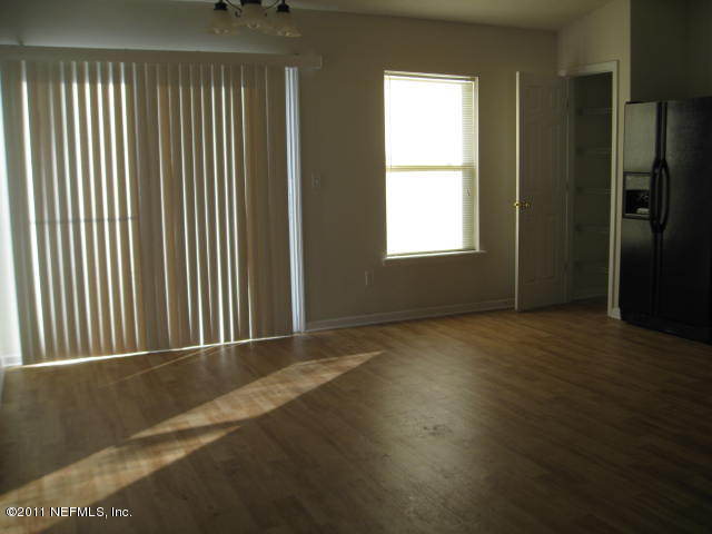 1108 Dawn Light Road Jacksonville, FL 32218 - Photo 5 of 19 an empty room with wooden floor and windows