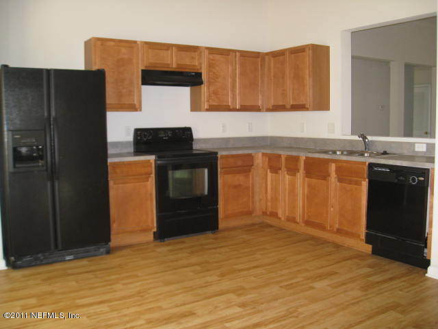 1108 Dawn Light Road Jacksonville, FL 32218 - Photo 6 of 19 a kitchen with stainless steel appliances granite countertop a sink stove and refrigerator