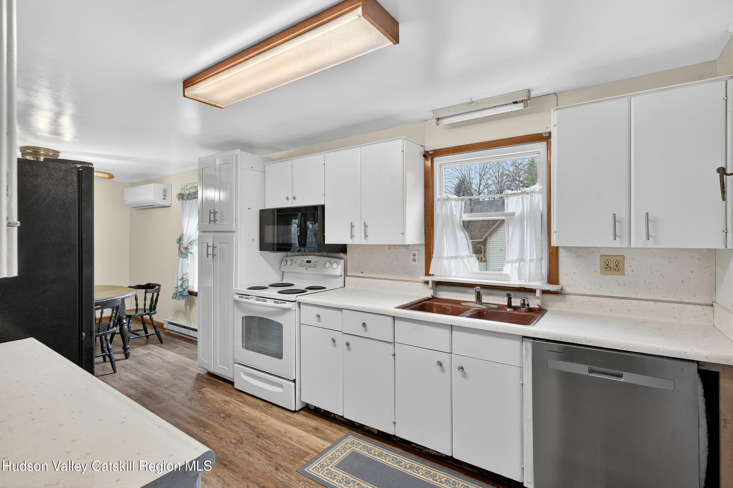 4030 Us Highway Stone Ridge, NY 12484 - Photo 11 of 22 a kitchen with a sink stove and refrigerator