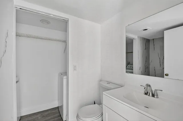 a bathroom with a toilet sink and a mirror