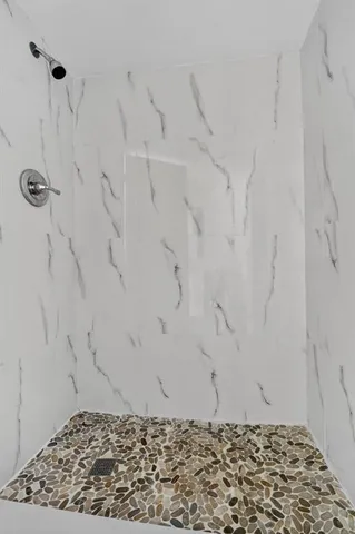 a kitchen with granite countertop white cabinets and stainless steel appliances