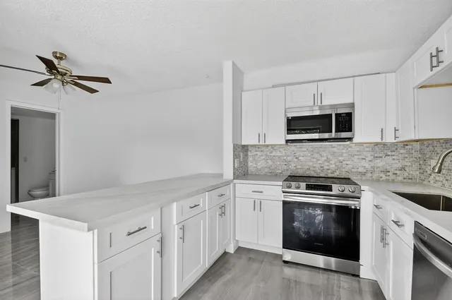 a view of a hallway with stairs and furniture