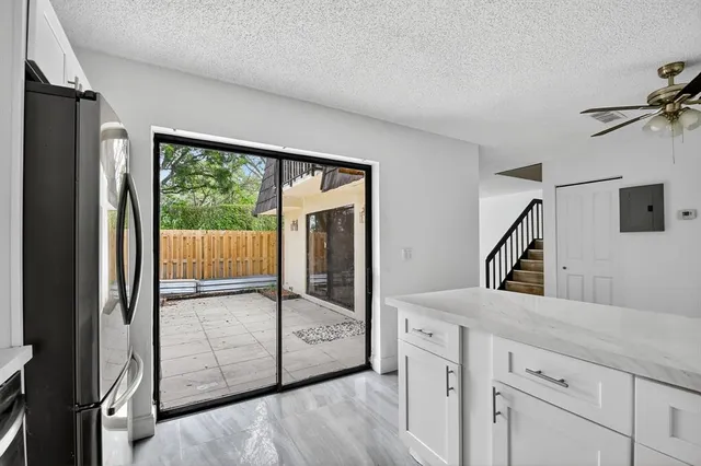 a kitchen with stainless steel appliances white cabinets and a refrigerator