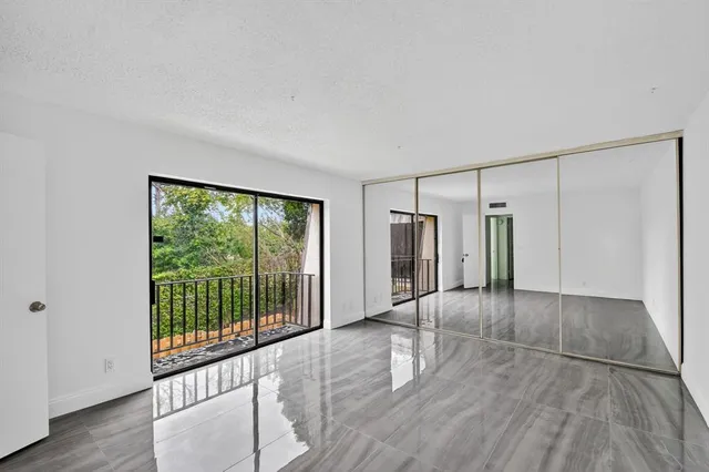 a view of a room with wooden floor and doors