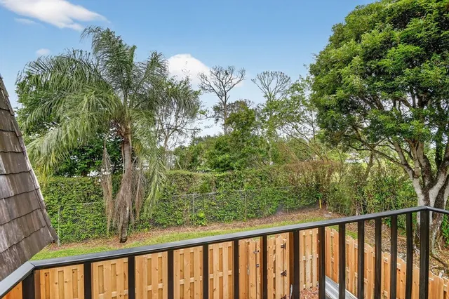 a view of a balcony with wooden fence and floor