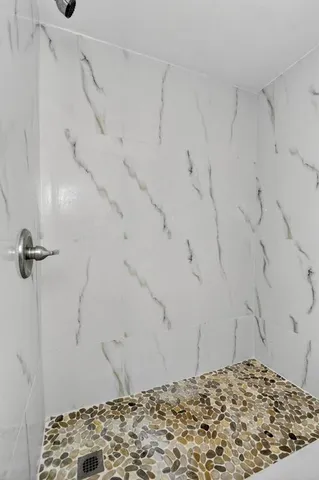 a view of a small space with wooden floor and a window