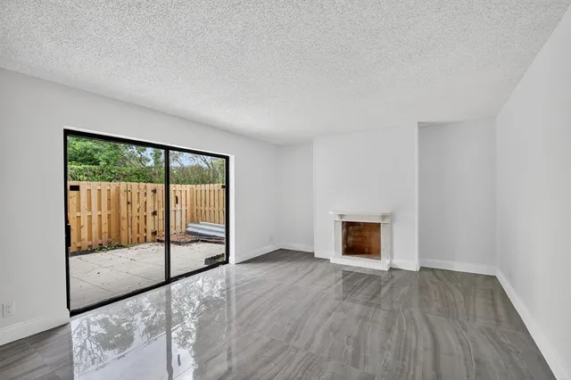 wooden floor fireplace and natural light in room