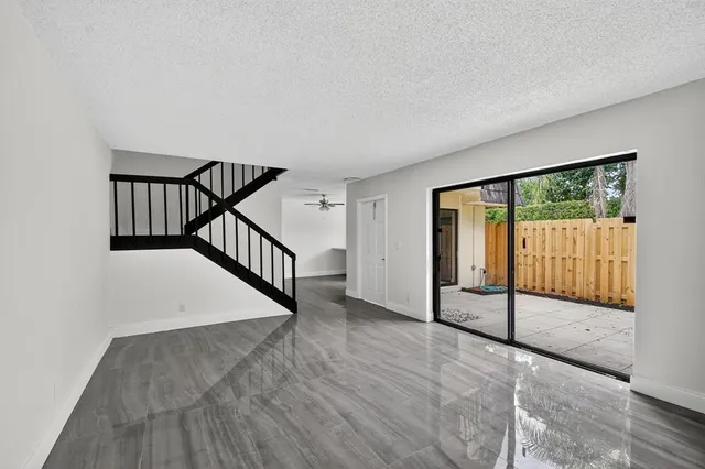 a view of a hallway with wooden floor and entryway
