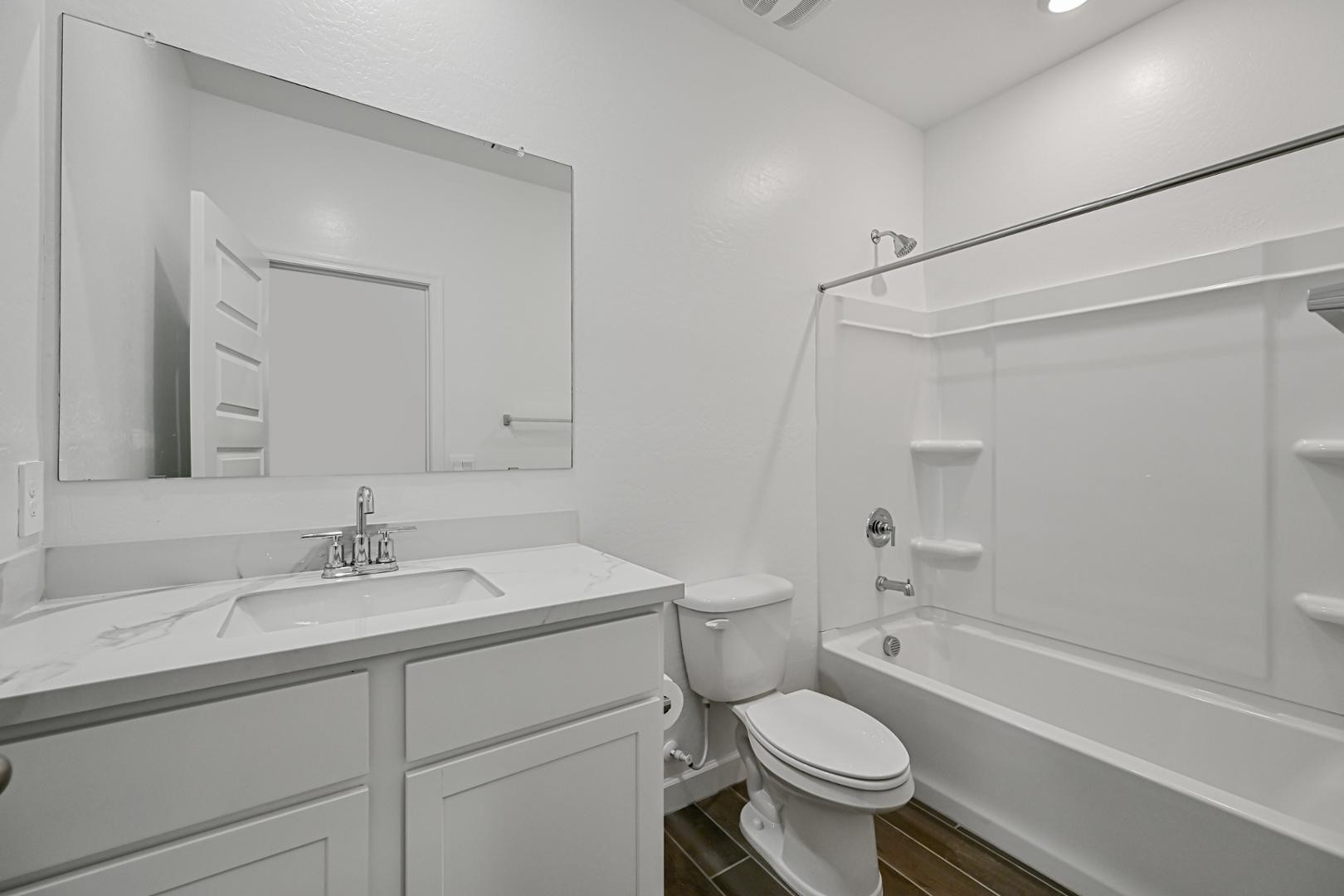 2129 West Spaulding Avenue Apache Junction, AZ 85120 - Photo 13 of 28 a bathroom with a sink toilet vanity and shower
