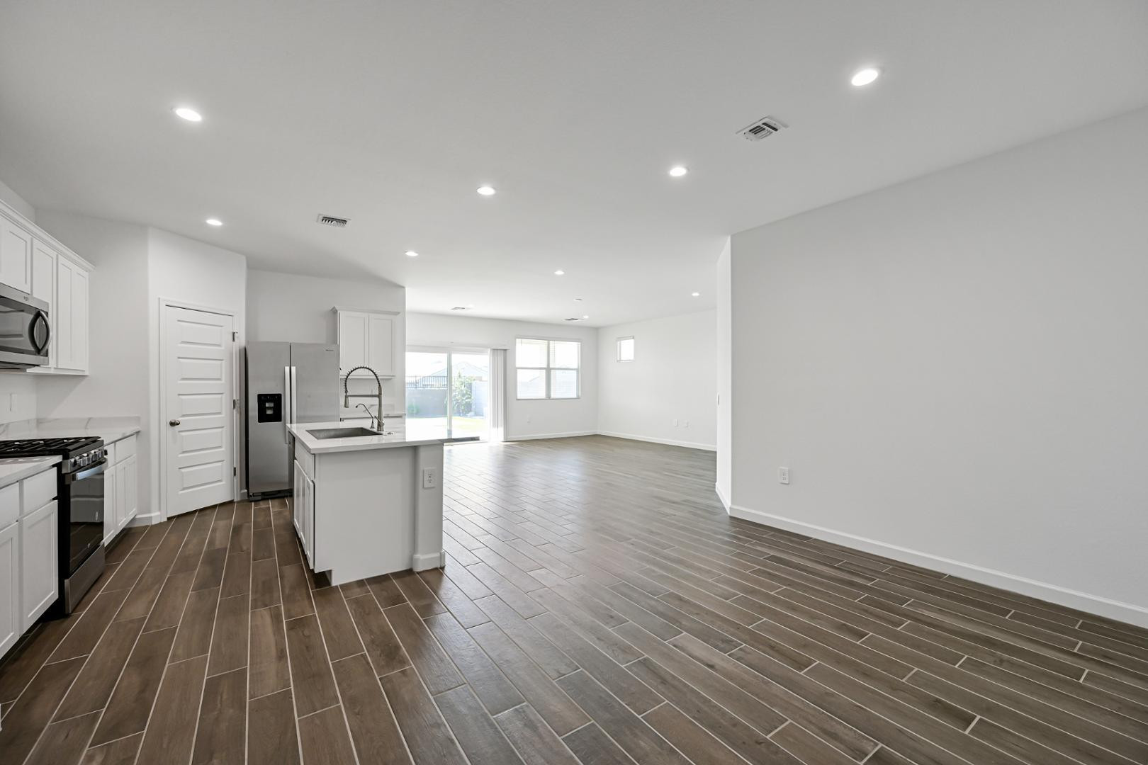 2129 West Spaulding Avenue Apache Junction, AZ 85120 - Photo 3 of 28 a view of kitchen with cabinets and wooden floor