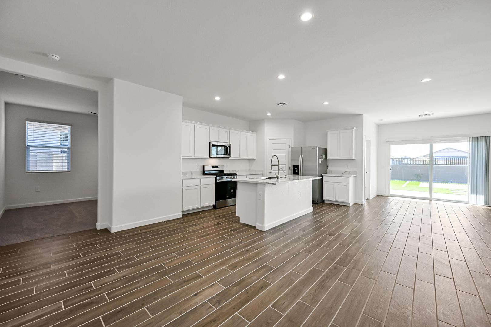 2129 West Spaulding Avenue Apache Junction, AZ 85120 - Photo 6 of 28 a large kitchen with kitchen island a sink table and chairs