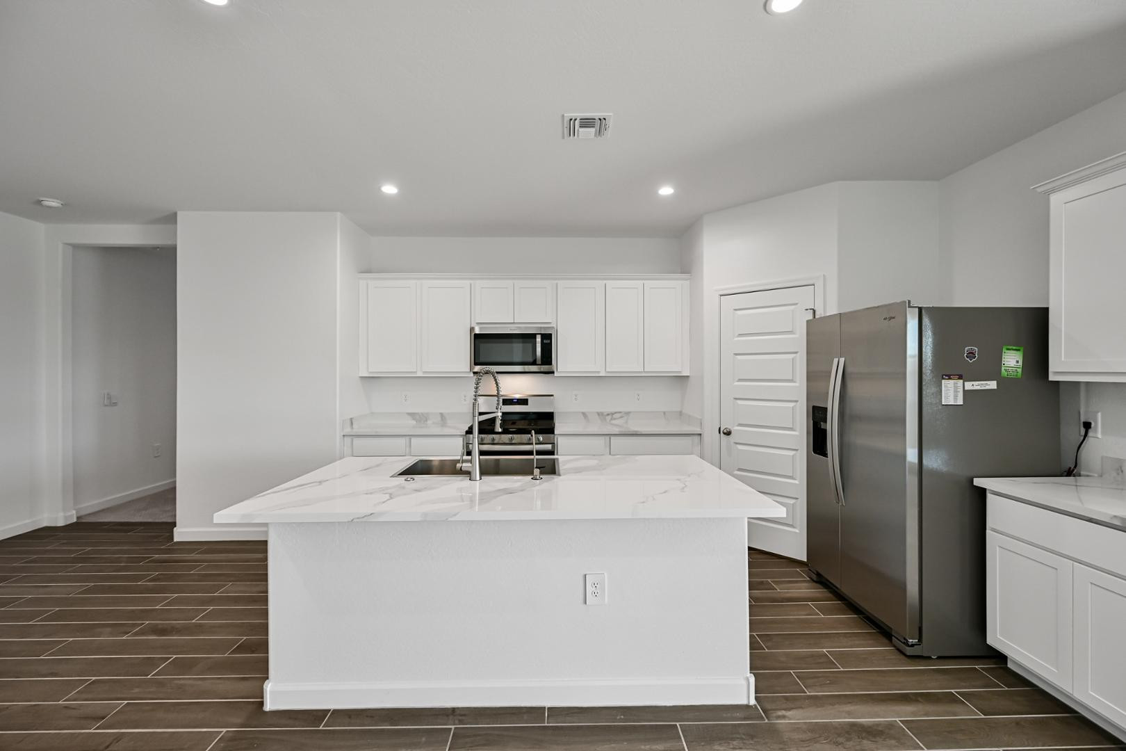 2129 West Spaulding Avenue Apache Junction, AZ 85120 - Photo 8 of 28 a kitchen with stainless steel appliances kitchen island granite countertop a stove a refrigerator and a refrigerator