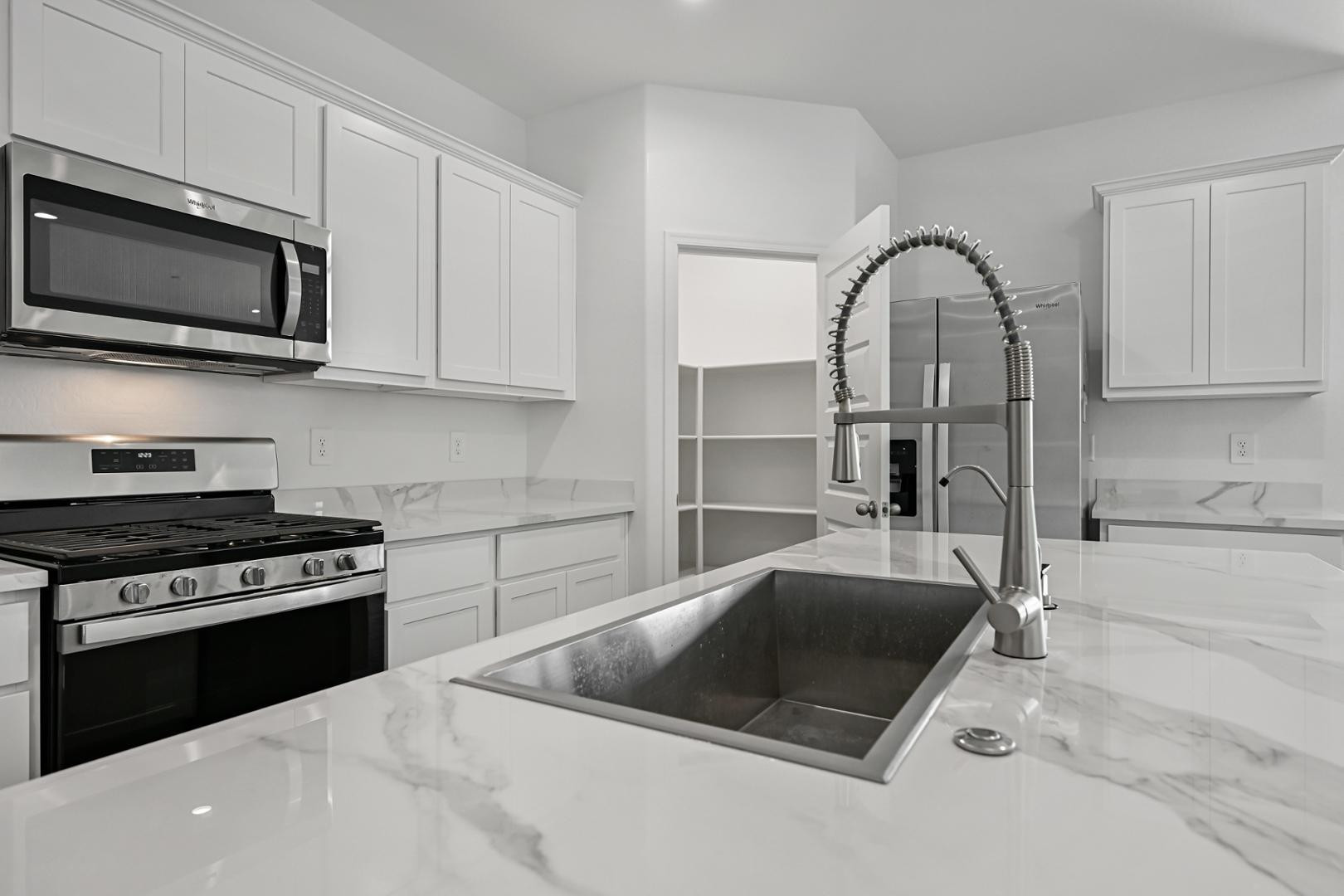 2129 West Spaulding Avenue Apache Junction, AZ 85120 - Photo 10 of 28 a kitchen with stainless steel appliances a stove a sink and microwave