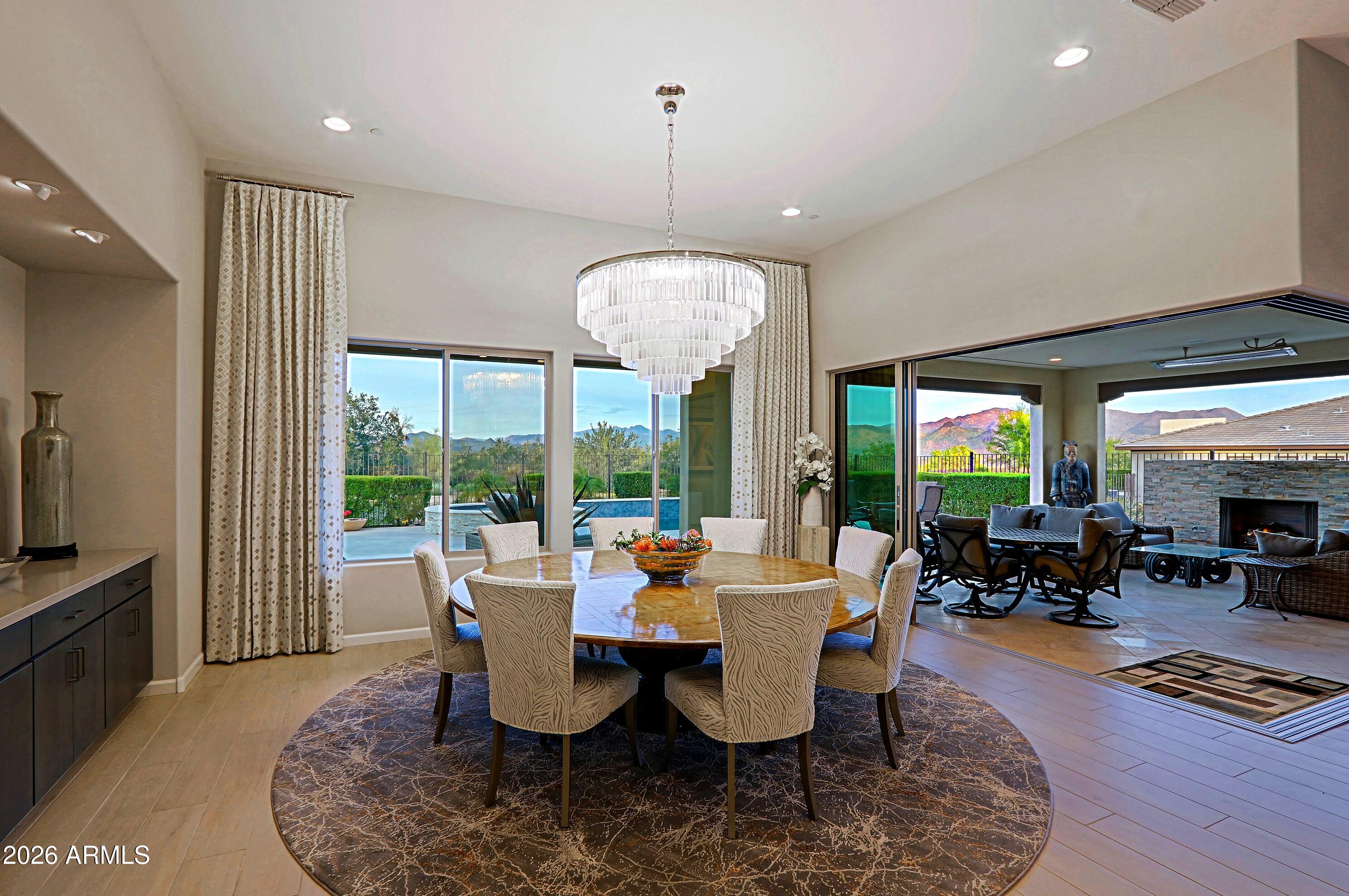 17864 East Paria Canyon Drive Rio Verde, AZ 85263 - Photo 11 of 66 a dining room with furniture a chandelier and wooden floor