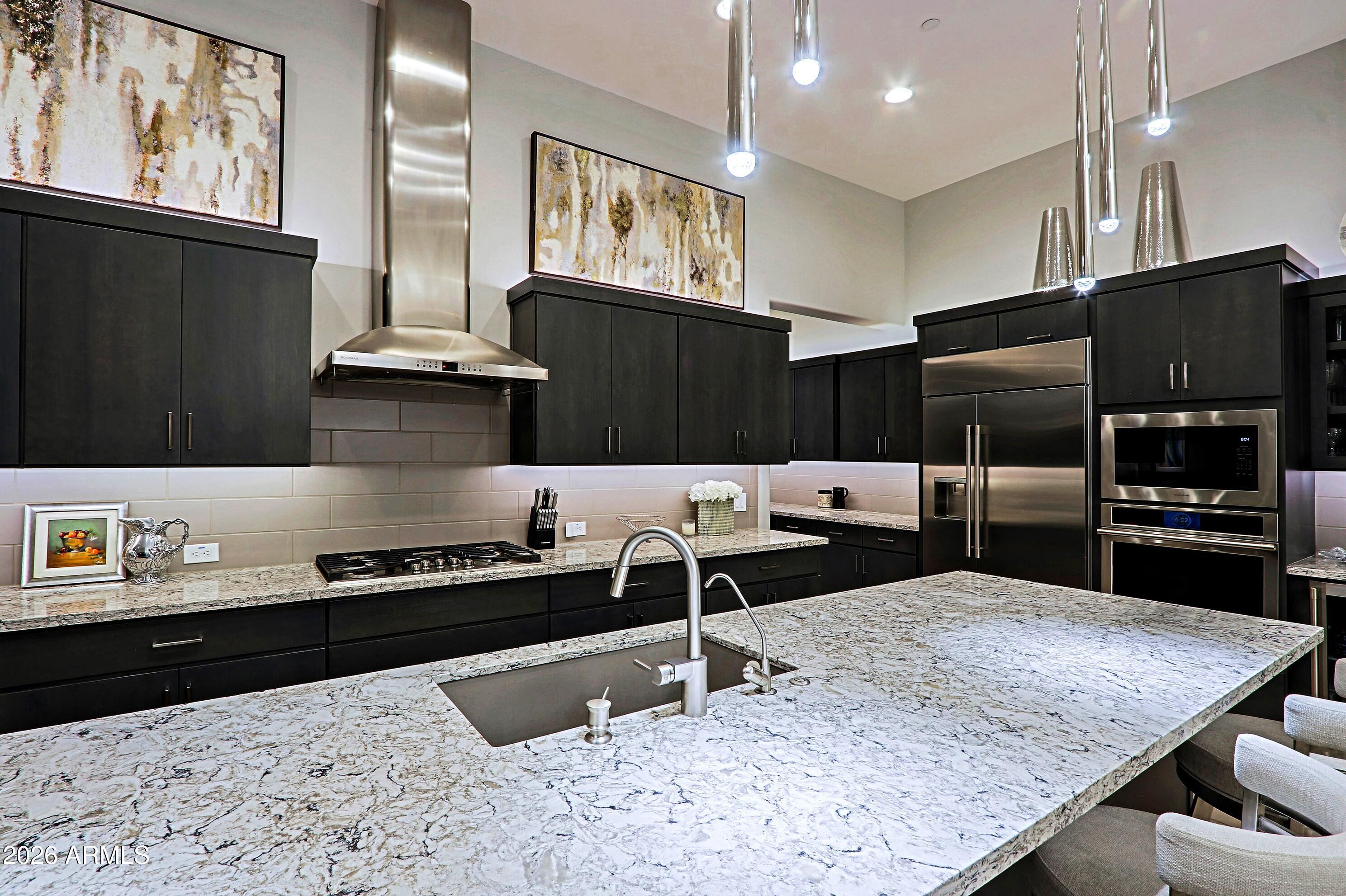 17864 East Paria Canyon Drive Rio Verde, AZ 85263 - Photo 14 of 66 a kitchen with stainless steel appliances kitchen island granite countertop a refrigerator and a stove top oven