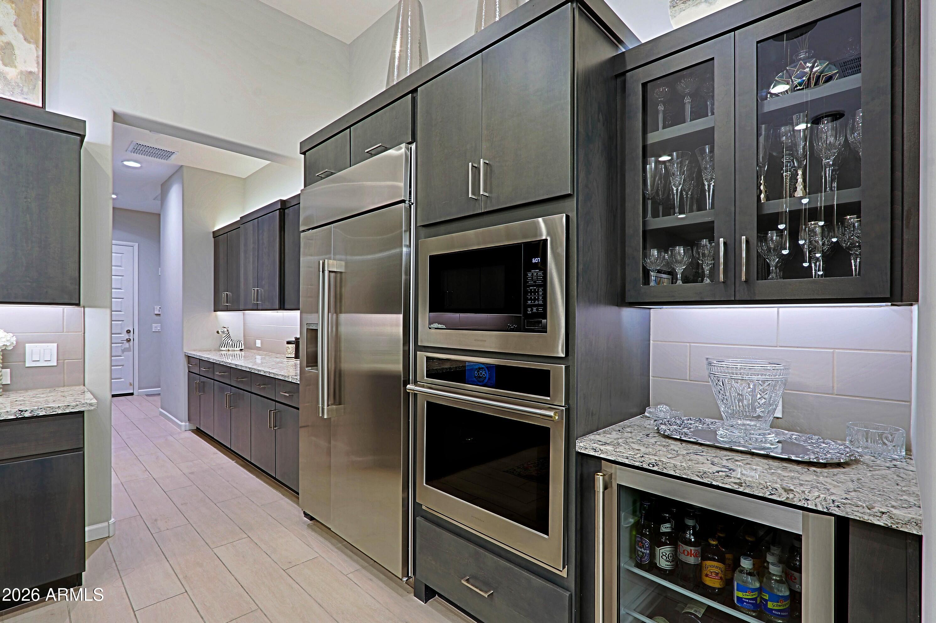 17864 East Paria Canyon Drive Rio Verde, AZ 85263 - Photo 18 of 66 a kitchen with granite countertop a stove and a refrigerator