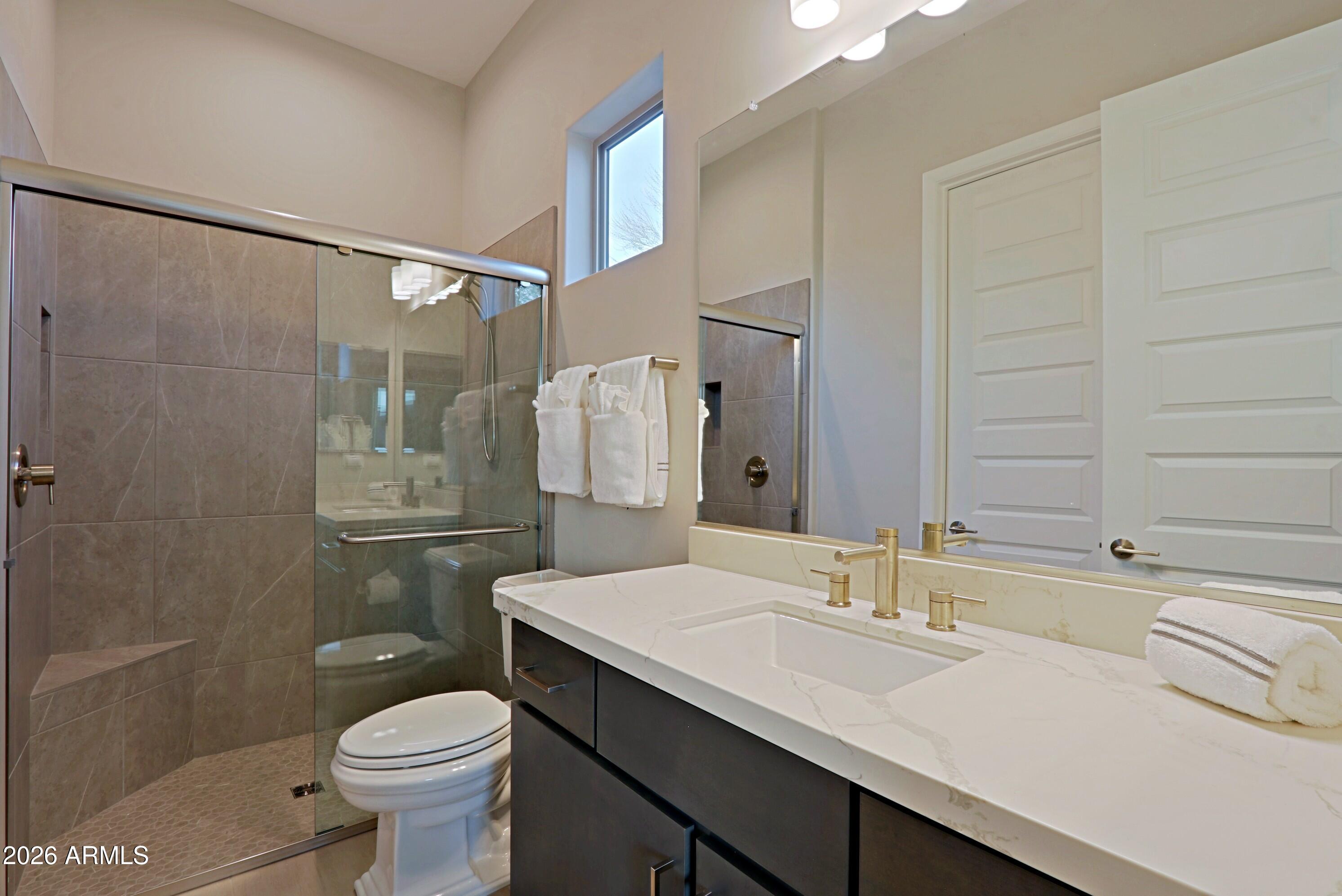 17864 East Paria Canyon Drive Rio Verde, AZ 85263 - Photo 32 of 66 a bathroom with a sink toilet a mirror and shower