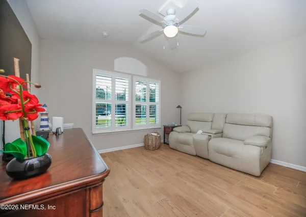 a living room with furniture and a potted plant