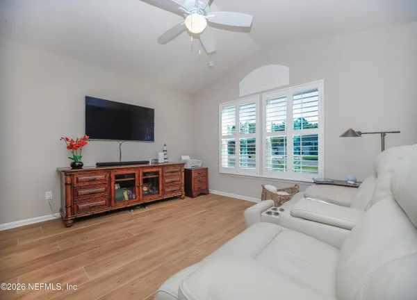 a living room with furniture and flat screen tv