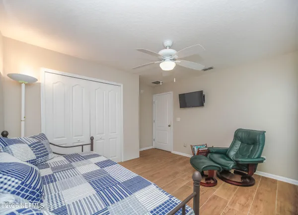 a bedroom with a bed window and a chair
