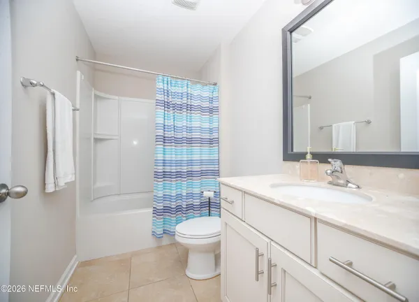 a bathroom with a granite countertop toilet sink and shower