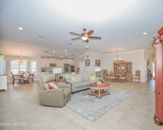 a living room with furniture and kitchen view