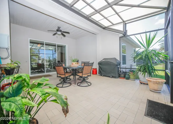 a living room filled with furniture and a potted plant
