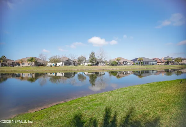 a view of a lake with houses in the back