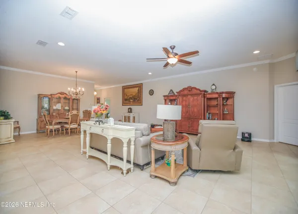 a living room with furniture a dining table and chairs with kitchen view