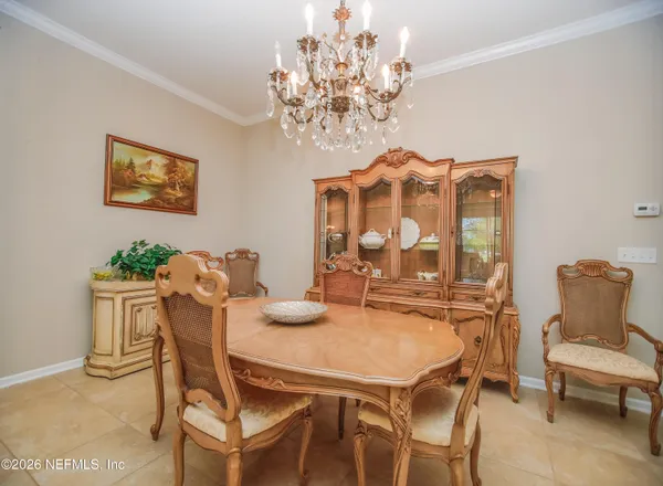 a view of a dining room with furniture and chandelier