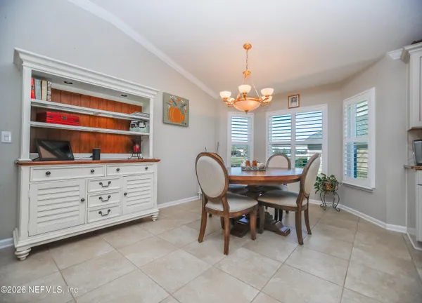 a view of a dining room with furniture and chandelier