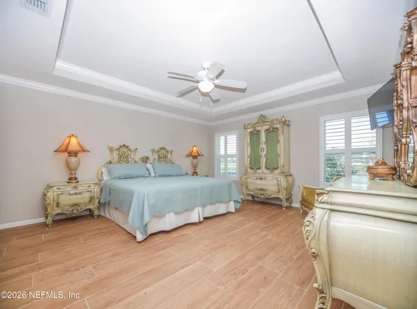 a bedroom with a bed and a chandelier