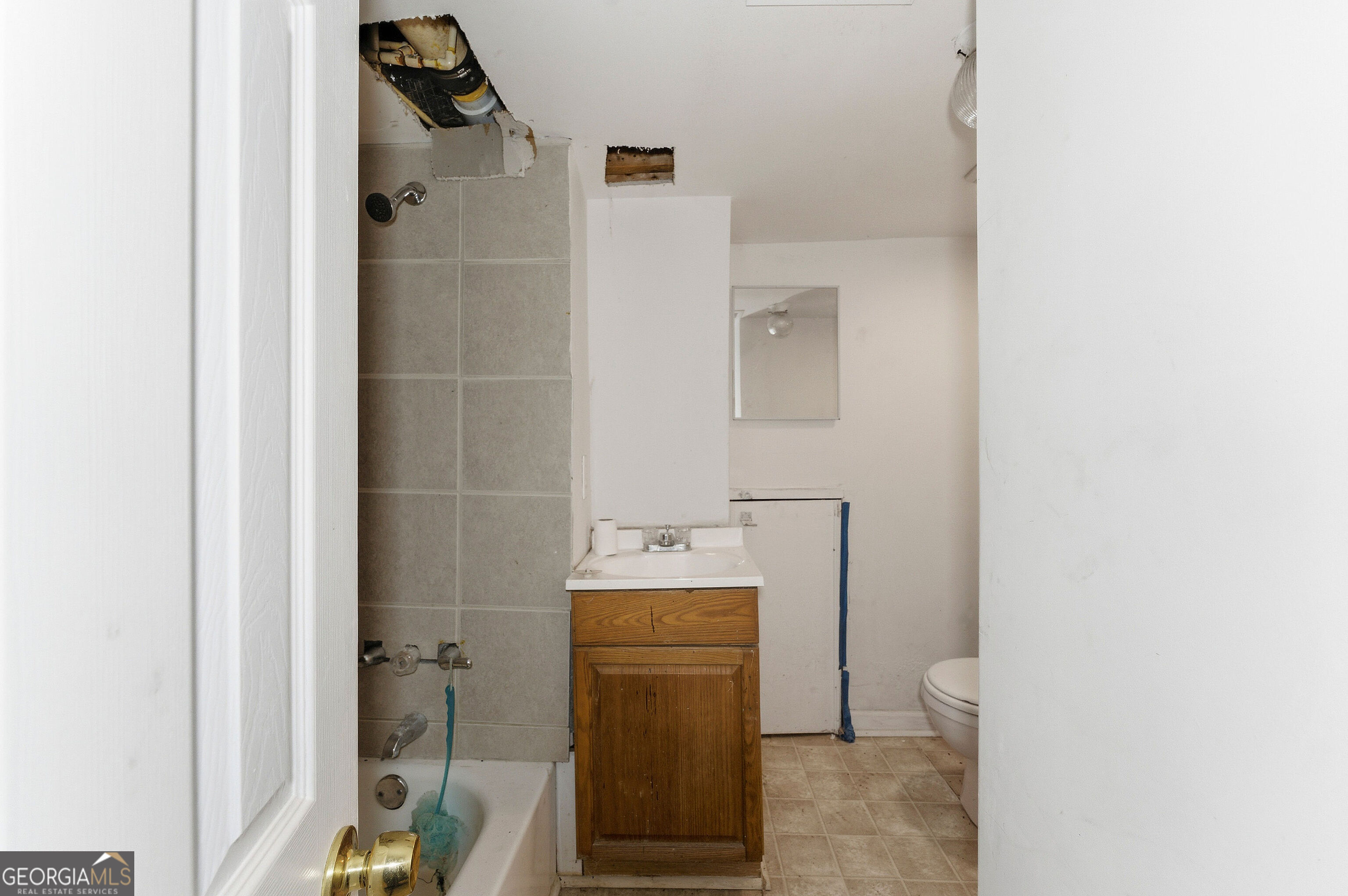 2848 Gresham Rd S East Atlanta, GA 30316 - Photo 17 of 20 a bathroom with a sink toilet and shower