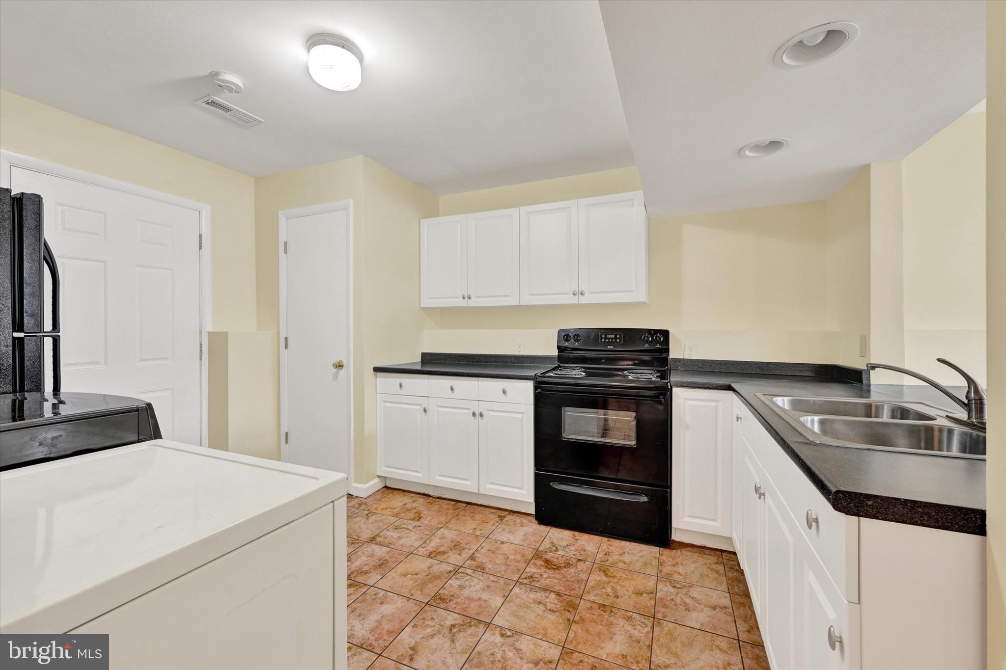 21 Box Circle Baltimore, MD 21221 - Photo 16 of 23 a kitchen with a stove and a sink