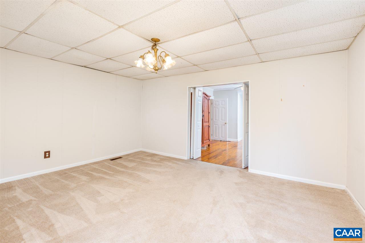 53 McKamy Springs Road Middlebrook, VA 24459 - Photo 20 of 46 an empty room with chandelier fan and windows