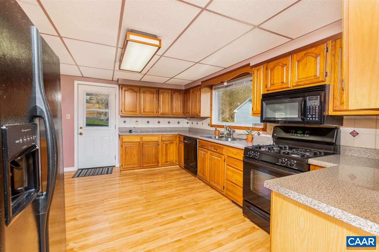 53 McKamy Springs Road Middlebrook, VA 24459 - Photo 7 of 46 a kitchen with stainless steel appliances granite countertop a refrigerator a stove top oven a sink dishwasher and wooden cabinets